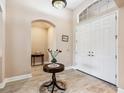 Inviting foyer features tile flooring, a decorative light fixture, and double entry doors at 2496 Farms Ct, Sarasota, FL 34240