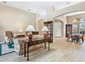 Inviting living room showcasing a floral couch, wooden table with lamps, and open floor plan at 2496 Farms Ct, Sarasota, FL 34240