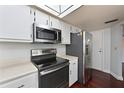 Well-equipped kitchen with stainless steel appliances, white cabinetry, and a modern range hood at 2901 26Th W St # 312, Bradenton, FL 34205