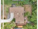Aerial view of a well-maintained home with mature trees and greenery, including a driveway and backyard at 3006 Wister Cir, Valrico, FL 33596