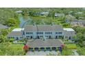 Wide aerial view of the multi-Gathering home with carport parking and well manicured landscaping at 33 Bishops Court Rd # 118, Osprey, FL 34229