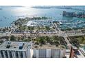 Stunning aerial view of a marina and waterfront condos with beautiful bay views on a sunny day at 33 S Gulfstream Ave # 502, Sarasota, FL 34236