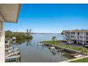 Scenic waterfront view featuring lush landscaping, multiple docks and calm waterways with boats at 3320 Gulf Of Mexico Dr # 307C, Longboat Key, FL 34228
