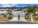 Aerial view of a single-story home featuring a large driveway, two-car garage, and backyard at 3666 Bonaventure Ct, Sarasota, FL 34243