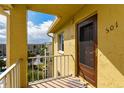 Condo 501's front door with yellow walls, overlooking the property at 3740 Lake Bayshore Dr # Bldg K, Bradenton, FL 34205