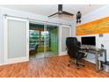 A home office with glass sliding doors leading to a sunroom at 3740 Lake Bayshore Dr # 501, Bradenton, FL 34205
