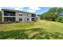Backyard view of building, showing a walkout area, green grass, and nice scenery at 383 Bobby Jones Rd # 383, Sarasota, FL 34232