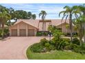 Charming home with a three-car garage, beautiful landscaping, and a circular paver driveway at 3936 Spyglass Hill Rd, Sarasota, FL 34238