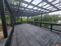 Enjoy outdoor living on this wooden deck overlooking a serene lake and lush greenery at 4210 Baird St, Sarasota, FL 34232