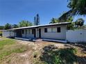 Single story home with an attached carport, white privacy fencing and mature landscaping at 4210 Baird St, Sarasota, FL 34232