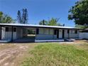 Beautiful single story home featuring a metal roof, front carport and clean landscaping at 4210 Baird St, Sarasota, FL 34232