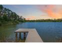 Lakefront property with a private wooden dock perfect for fishing or enjoying the sunset at 4225 Ulman Ave, North Port, FL 34286