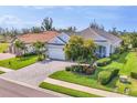Inviting single-story home features a beautiful landscape, neutral paint, and brick-paved driveway at 523 Wildlife Gln, Bradenton, FL 34209