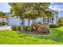 Lovely single-Gathering home featuring lush landscaping, stone accents, a two-car garage, and a front lawn at 523 Wildlife Gln, Bradenton, FL 34209