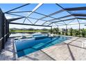 Stunning screened pool with a spa and tranquil lake views; offers a luxurious outdoor retreat at 5333 Coral Reef Way, Bradenton, FL 34211