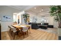 Open-concept living space featuring modern decor, hardwood floors, and abundant natural light at 553 Meadow Sweet Cir, Osprey, FL 34229