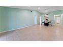 Bright open living space with neutral tile flooring, ceiling fan, and direct access to the kitchen at 5709 13Th W Ave, Bradenton, FL 34209