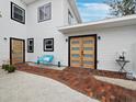 A vibrant exterior with an eye-catching door design with an inviting seating area at 580 Russell St, Longboat Key, FL 34228