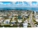 Waterfront living is exemplified in this home with canal access to Tampa Bay and a metal roof at 602 Baronet Ln, Holmes Beach, FL 34217