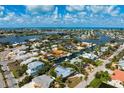 Enjoy stunning waterfront views from this home with direct canal access and lush tropical landscaping at 602 Baronet Ln, Holmes Beach, FL 34217