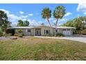 Charming single-story home featuring a brick driveway, a two-car garage, and lush green lawn at 602 Baronet Ln, Holmes Beach, FL 34217
