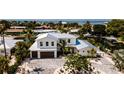 Beautiful two-story home with a spacious driveway and lush landscaping, offering curb appeal and comfort at 603 Emerald Ln, Holmes Beach, FL 34217