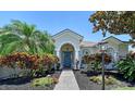 Inviting home entrance showcasing a blue front door, lovely landscaping, and rocking chairs at 6539 Flycatcher Ln, Lakewood Ranch, FL 34202