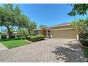 Attractive property with a brick paved driveway leading to an attached two-car garage at 6605 38Th E Ln, Sarasota, FL 34243