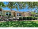 Inviting home exterior with manicured landscaping, a vibrant lawn, and mature trees for shade at 6605 38Th E Ln, Sarasota, FL 34243