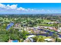Stunning aerial view showcasing canal-front homes and lush greenery at 6931 Magellan Way, Sarasota, FL 34243