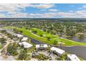 Aerial view of this property showcasing the prime golf course community and water views at 7193 W Country Club N Dr # 137, Sarasota, FL 34243