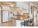 Bright kitchen with white cabinets, granite countertops, and stainless-steel appliances at 7193 W Country Club N Dr # 137, Sarasota, FL 34243