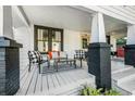 Cozy front porch features stylish seating, black brick accents, and a welcoming ambiance at 720 37Th W St, Bradenton, FL 34205