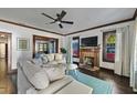 Bright living room with hardwood floors, a brick fireplace, and neutral-toned furnishings at 720 37Th W St, Bradenton, FL 34205