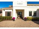 Charming entrance with a brick paver walkway, enhanced by colorful plants and well-maintained landscaping at 7208 Prestbury Cir, Bradenton, FL 34202