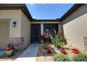 Front porch featuring vibrant landscaping, a charming entryway, and stone accents at 7311 64Th St E, Palmetto, FL 34221