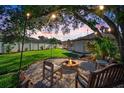 Cozy backyard fire pit area, perfect for gathering and enjoying outdoor evenings under the soft glow of string lights at 8321 9Th Avenue Nw Ter, Bradenton, FL 34209