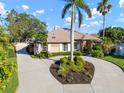 Beautiful home featuring a circular driveway, manicured landscaping, and a welcoming facade on a sunny day at 8321 9Th Avenue Nw Ter, Bradenton, FL 34209