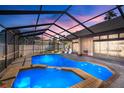 Enjoy the private screened-in pool with a spa, ideal for relaxing and entertaining outdoors with a beautiful twilight overhead at 8321 9Th Avenue Nw Ter, Bradenton, FL 34209