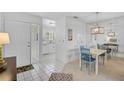 Inviting dining area with white tile floors and charming blue chairs at 939 Sandpiper Cir, Bradenton, FL 34209