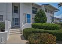 Well-manicured condo exterior with a blue front door, showcasing a welcoming entrance at 939 Sandpiper Cir, Bradenton, FL 34209