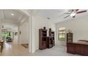 Inviting home office space with ceiling fan, neutral carpet, and arched doorways at 9769 Highland Park Pl, Palmetto, FL 34221