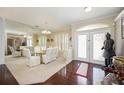 Formal dining room with a glass table, elegant chairs, and ample natural light at 10523 Old Grove Cir, Bradenton, FL 34212