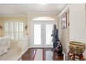 Foyer with hardwood floors, a decorative statue, and a bright, welcoming atmosphere at 10523 Old Grove Cir, Bradenton, FL 34212