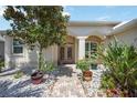 Inviting front entrance with a brick walkway, lush plants, and manicured landscaping at 10523 Old Grove Cir, Bradenton, FL 34212