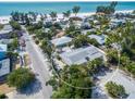Aerial view highlighting the property's location near the beach and mature trees at 112 Palm Ave, Anna Maria, FL 34216