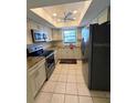 Well-lit kitchen featuring granite counters, white cabinetry, and stainless steel appliances at 1304 56Th W St, Bradenton, FL 34209
