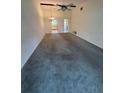 Spacious living room with high ceiling, fan, and views into kitchen at 1304 56Th W St, Bradenton, FL 34209