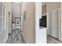 Inviting hallway with wood floors leads to the living area and kitchen with white trim at 1322 Perico Point Cir, Bradenton, FL 34209