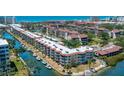 Aerial view of waterfront condos with boat docks, landscaping and beautiful water views at 1350 N Portofino Dr # 208, Sarasota, FL 34242